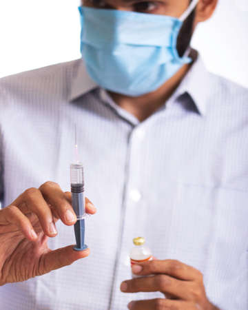 Doctor holding vaccine and syringe.の写真素材