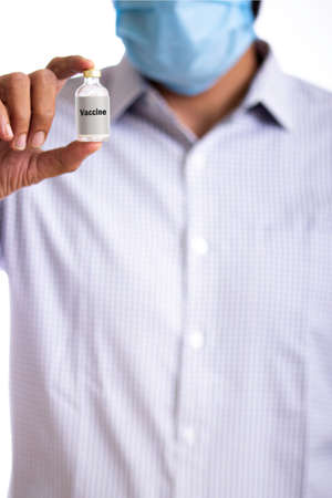 Doctor holding covid 19 vaccineの写真素材