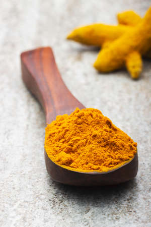 indian spices in wooden spoon on dark backgroundの写真素材