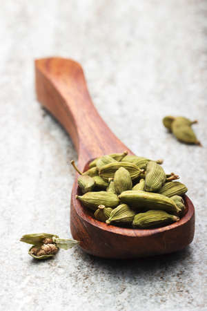 indian spices in wooden spoon on dark backgroundの写真素材