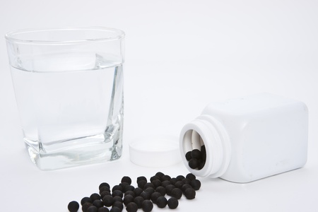 Herbal medicine pill with a glass waterの写真素材