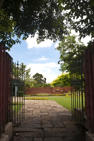 The iron gate entrance to peaceful flower gardenの写真素材