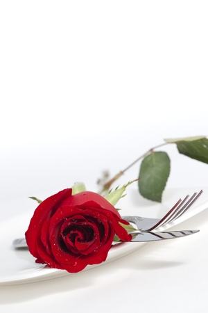 Valentine Series, Red rose and cutlery on white plateの写真素材