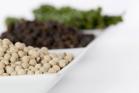 Hot and Spicy Black, White and Green Pepper on white backgroundの写真素材