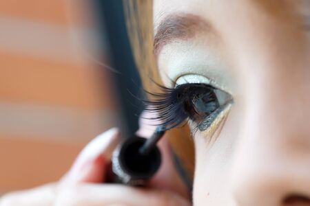 Applying liquid eyeliner with brush, close up の写真素材