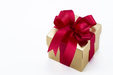 Beautiful gold present box with red bow and ribbons on white backgound
