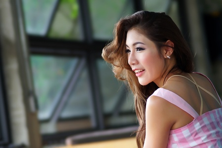 Beautiful young woman posing alone in the cafe, Model is Thai Ethnicity.の写真素材