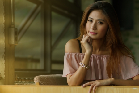 Beautiful young woman posing alone in the cafe, Model is Thai Ethnicity.の写真素材