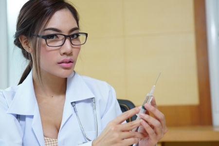 Medical doctor woman holding syringe.の写真素材