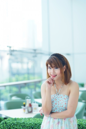 Beautiful young woman posing in a restaurant.の写真素材