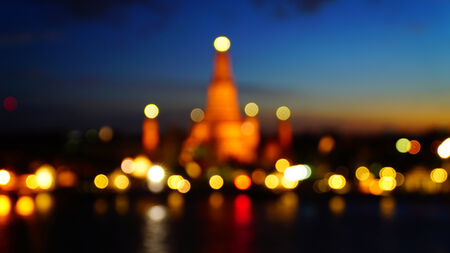 Twilight time of Wat Arun across Chao Phraya River during sunset in Bangkok, Thailand, Defocused blur bokeh background  の写真素材