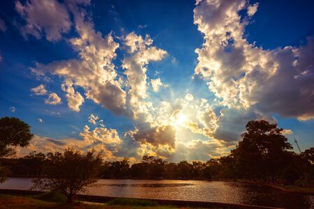 Sunset scene on lake with beautiful clouds and sky.の写真素材