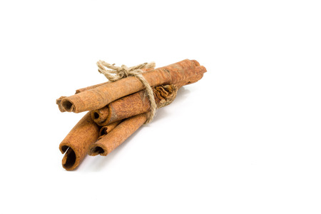 Cinnamon sticks tied by rope isolated on white background.の写真素材