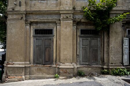 Old wooden window, detail of a building in ruins and abandonedの写真素材