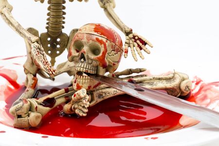 Still life skeleton in blood with knife on white background, Halloween conceptの写真素材