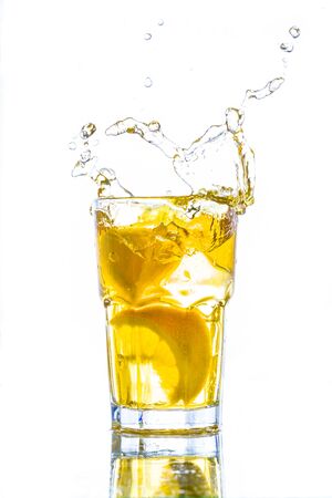 Ice tea with lemon splash, Isolated white backgroundの写真素材