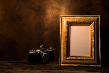 Still life of picture frame on table with vintage camera.の写真素材