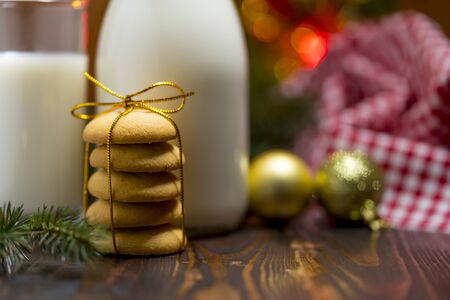 Cookie and milk on wooden table for Santa Claus, selected focus, shallow DOFの写真素材