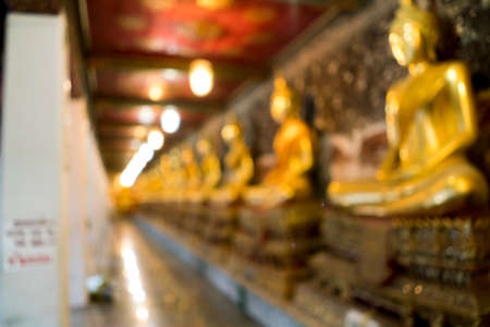 Blurred image of Buddha statue row at wat suthat in Bangkok, Thailand, for background uses.の写真素材