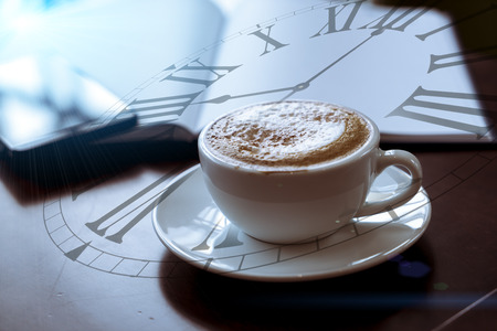 Double exposure of coffee cup with clock face. Cross Processedの写真素材