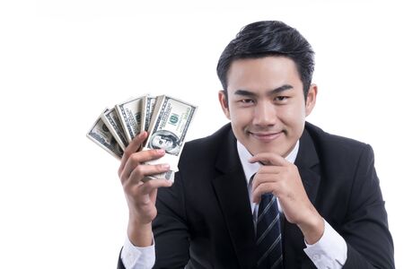 Portrait happy young businessman holding money with hand on chin and smiling on white background and coppyspace, concept : business, success and happiness
の写真素材
