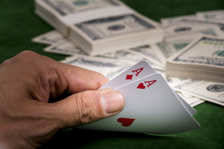 The Hands show chance of winning blackjack game and a pile of dollars on the table at casino
の写真素材