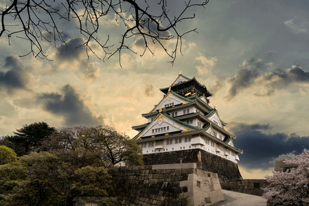 Osaka castle the ancient buildings and beautiful stand out among the clouds on sky and surrounded by Sakura or cherry blossom, the popular and unique province of Osaka, Japanのeditorial素材
