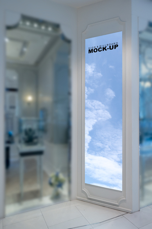 The blank vertical or portrait mock up billboard for advertising stand at modern shop on the sidewalk inside the shopping mall,  with clipping pathの写真素材