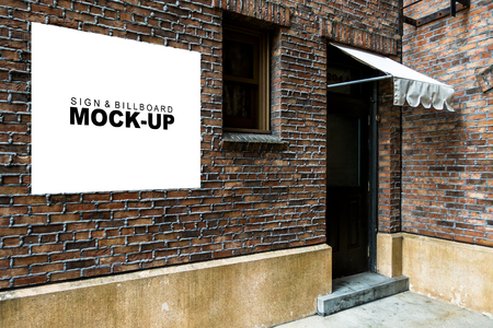 The mock up empty billboard on the wall of shop or restaurant, blank white signboard for promotion or information at the front of building with clipping path,の写真素材
