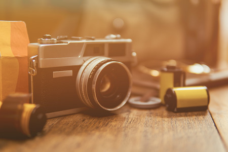 Vintage camera and films on a wooden table, retro toneの写真素材