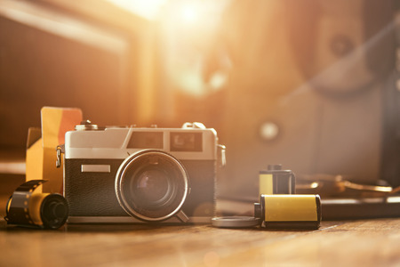 Vintage camera and films on a wooden table, retro toneの写真素材