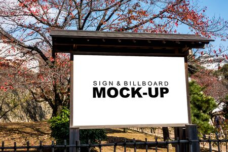 The mock up blank white screen big wooden billboard at park or tourist attraction, for insert advertisement or information and map of that area, and beautiful garden backgroundの写真素材