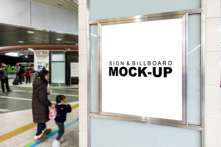 The mock up signboard with blank white and frame on glass wall of building for advertising or information  , blurred people walkingの写真素材
