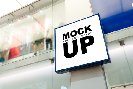 The mock up of square shape signboard or signage shop display and blue frame with clipping path, blurred showcase of fashion backgroundの写真素材