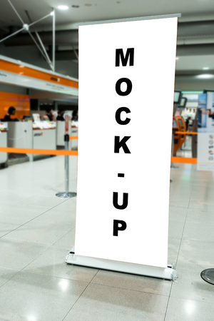 Mock up blank space on roll stand advertising signboard in airport with clipping path, free copy...