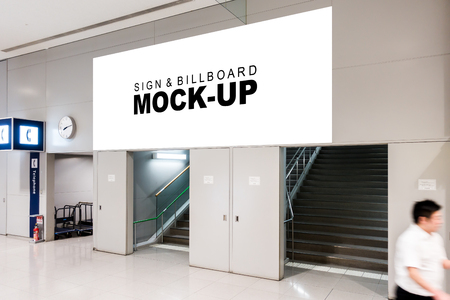 The mock up of horizontal blank billboard over on the entrance at airport area, Empty space white screen for advertisement and blurred people walkingの写真素材