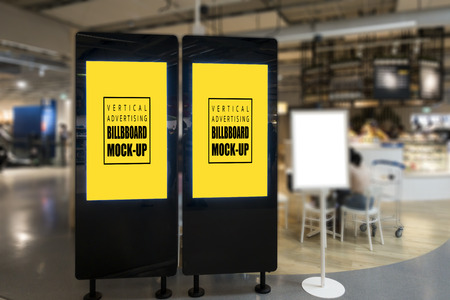 Mock up two blank promotion poster display with clipping path on black partition in shopping mall, empty space with yellow screen for advertising ,information or announcementの写真素材