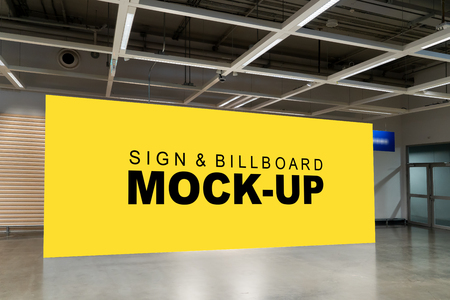 Mock up perspective large horizontal advertising billboard with clipping path on the wall at hallway near entrance door, blank yellow screen empty space for in formation advertisementの写真素材