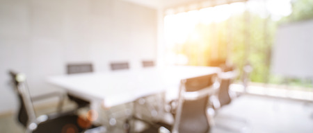 Blurred image of meeting room in the modern office, evening time with sunlight - ideal for presentation background.の写真素材