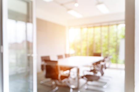 Blurred image of meeting room in the modern office, evening time with sunlight - ideal for presentation background.の写真素材