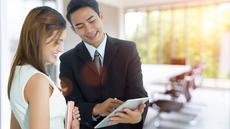 Couple colleagues discussing their project in the meeting room. Selective focus at businessman.の写真素材