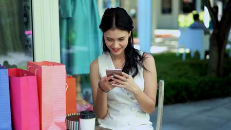 The young pretty woman used application in smartphone camera to chat with joyfulの写真素材