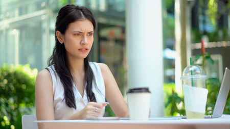 Close up the young woman sitting with a handful anger and seriouslyの写真素材
