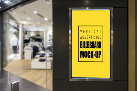 Mock up vertical advertising blank yellow screen billboard with clipping path for insert text message or media content at front of fashion clothing store, marketing and advertisement conceptの写真素材