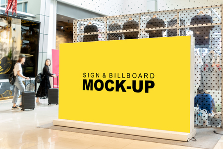 Mock up blank horizontal billboard for advertising with clipping path, perspective empty yellow space for insert text or media promotion, information signboard stand outdoor at corridor shopping mallの写真素材