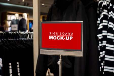 Mock up blank desktop label on steel pole with clipping path, perspective red screen the empty space for insert text or advertising promotion in shop clothingの写真素材