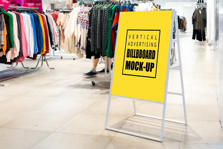 Mock up vertical blank banner or signboard with clipping path to show promotion or discount in shop clothing, Yellow screen empty space for insert text or advertising in shopping mallの写真素材