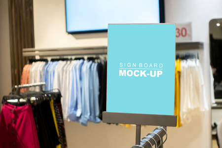 Mock up vertical blank banner or signboard with clipping path to show promotion or discount in shop clothing, Blue screen empty space for insert text or advertising in shop clothingの写真素材