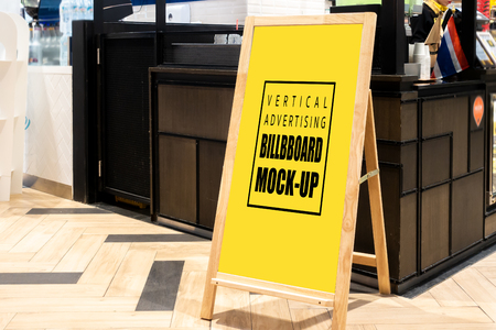 Mock up vertical blank chalkboard standing with clipping path at front of restaurant, Yellow screen empty space for insert text menu or advertising or announcementの写真素材