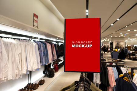 Mock up vertical blank banner or signboard on hanger   to show promotion or discount in shop clothing, red screen empty space for insert text or advertising in shopping mallの写真素材